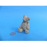 A vintage miniature Teddy Bear, probably Schuco, 3½in (9cm) high.