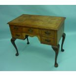 A late 19th century walnut Lowboy, the quarter-veneered top with moulded edge above an arrangement