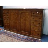 A late 19thC Aesthetic Movement burr pitch pine Gillows-style dwarf linen press, with symmetrical