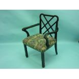 A Chinese Chippendale-style ebonised open Armchair, the shaped crest above a geometric pierced