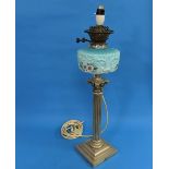 A late 19thC silver plated Corinthian Column Oil Lamp, blue glass reservoir painted with flowers,