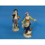 A pair of antique porcelain figures emblematic of Summer, she standing before a tree stump with