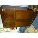 A early 20thC mahogany Heals Gentleman's Compactum wardrobe, with quarter-veneered panels on