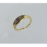 A small 18ct yellow gold Ring, the flared front set with graduated rubies and diamonds, Size J.