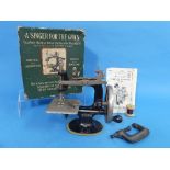 An early 20thC 'Singer for the Girls' Miniature Sewing Machine, complete with clamp and