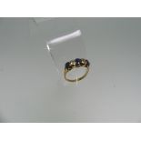 A five stone sapphire and diamond Ring, the three oval facetted sapphires with a diamond between,