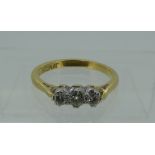 A small three stone diamond Ring, mounted in 18ct yellow gold and platinum, Size J.