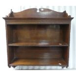 An Edwardian mahogany set of Hanging Shelves, comprising three open shelves, topped with a foliate