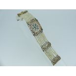 An attractive seed pearl and turquoise Bracelet, formed of a central square pierced plaque, set with