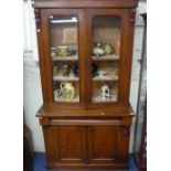 A Victorian mahogany Glazed Bookcase, with two glazed doors enclosing four adjustable shelves,