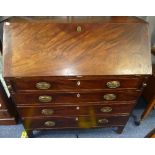 A Georgian mahogany Bureau, with hinged lid enclosing fitted compartments, above four long