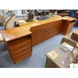 Mid 20thC Design: a retro Danish teak Bedhead, with integrated three-drawer bedside cabinets on