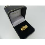 An 18ct yellow gold Buckle Ring, gypsy set with two diamonds, Size R½, approx total weight 5.2g