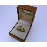 Clogau Gold; A 9ct yellow gold Ring, the flared front collet set with two diamond points and central