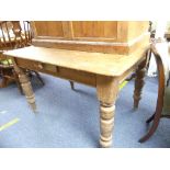 A 20thC pine Kitchen Table, of small size, with one central frieze drawer, upon bulbous turned legs,