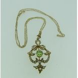 An Art Nouveau Pendant, set with seed pearls and a central facetted peridot, marked on the reverse