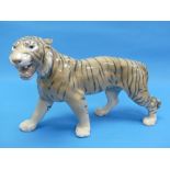 A Bing & Grondahl porcelain Tiger, No.2056, repaired back leg and cracked tail, 15in (38cm) long.