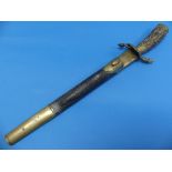 An early 20thC German Hunting Dagger, with antler grip, the brass crossguard in the form of