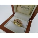 Clogau Gold; A 9ct yellow and rose gold 'Tree of Life' Trilogy Ring, the three diamonds collet set