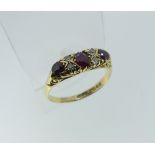 A graduated three stone Ruby Ring, each set with two diamonds between, all mounted in 18ct yellow