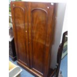 A Victorian mahogany two door Wardrobe, with pegs and hanging rails, and a hat compartment, lacks