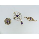 An Art Nouveau openwork Brooch, set with seed pearls and central amethyst with an amethyst drop,