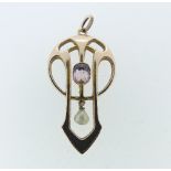 Liberty & Co.; An Art Nouveau 9ct rose gold Pendant, set in the centre with a pale amethyst and with