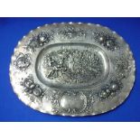 An early 20thC Continental silver oval Charger, in the Dutch style with repoussé decoration, the