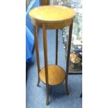 An antique oak Torchere, with circular top, splayed legs joined by a shelf, 13½in (34cm) wide x 13½