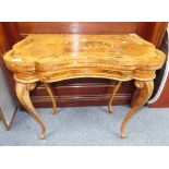 A 19thC Dutch marquetry walnut Tea Table, with serpentine shaped folding top opening to reveal