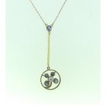 A small circular Pendant, the open centre set with four sapphires and a seed pearl with long bar