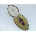 A Pendant, formed of four synthetic rubies with seed pearl centre, open backed and claw set in