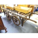 A Victorian oak Funeral Bier, comprising a chamfered oak ladder back coffin rack upon cast-iron