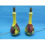 A pair of Moorcroft pottery Hibiscus pattern Table Lamps, one cracked at top of neck, 13½in (34.