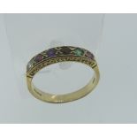 A 9ct yellow gold 'Regard' Ring, the circular facetted stones in an engraved gallery, Size N.