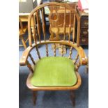 A pair of mid 20thC beech Windsor-back armchairs, with green padded seats, 43in (110cm) high x