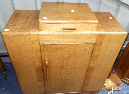 An Art Deco-style oak and mahogany Stepped Bookcase, comprising a central drawer upon a cupboard,