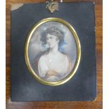 A 19th century portrait miniature of a classical youth, with long hair and wearing robes, oval,