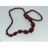 A string of graduated cherry Amber beads, largest bead 2.7mm, approx total weight 62g together