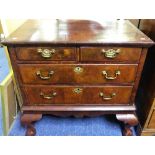 An Edwardian mahogany Chest of Drawers, the veneered top, above two short and two long drawers,