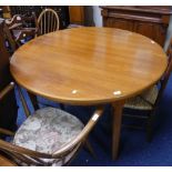 A mid 20thC retro teak Mackintosh Circular Extending Dining Table, with extra leaf fitted on the