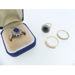 Two synthetic sapphire cluster Rings, surrounded by white pastes, one mounted in 9ct gold, the other