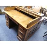 An early 20th century oak twin-pedestal roll-top Desk, by Cooke's (Finsbury) Ltd, the tambour top