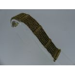 A Georgian gilt metal Bracelet, formed of six rows of cannetille decorated chain between six upright