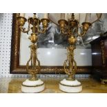 A pair of French Empire style three branch gilt metal and alabaster Candelabrum, moulded with