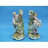 A Voigt Bros (Sitzendorf) porcelain pair of figural Candlesticks, he holding a bird and she