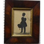 A 19th century silhouette of a Boy, full length, standing holding a tasseled cap, bears label