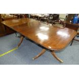 A George III mahogany twin pedestal Dining Table with one leaf, reeded edge, the feet terminating in