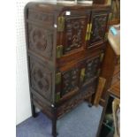 An early 20thC Chinese hardwood Cabinet, comprising a two tier double door cabinet of rounded