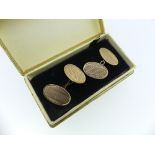 A pair of 9ct rose gold Cufflinks, of oval form with engine turned decoration, chain between, approx